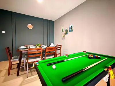a room with a pool table and a dining room at Ipoh Manhattan Waterpark 3BR Suite by City Home Empire MHB509 in Ipoh
