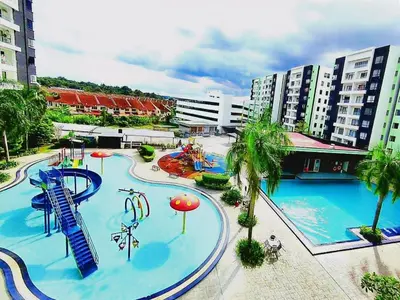 a large pool with a water park with a slide at Ipoh Manhattan Waterpark 3BR Suite by City Home Empire MHB509 in Ipoh