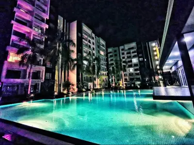 a large swimming pool in a city at night at Ipoh Manhattan Waterpark 3BR 8Pax Suite by City Home Empire MHA304 in Ipoh