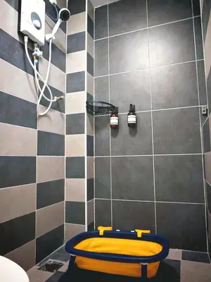 a bathroom with a yellow toilet in a shower at Ipoh Manhattan Waterpark 3BR 8Pax Suite by City Home Empire MHA304 in Ipoh