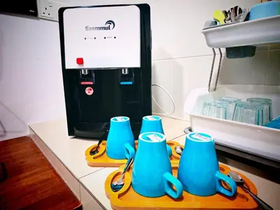 a group of blue cups sitting on a cutting board at Ipoh Manhattan Waterpark 3BR 8Pax Suite by City Home Empire MHA304 in Ipoh