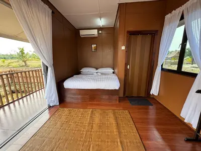a bedroom with a bed and a balcony at Akira Laman Padi Tg Karang in Tanjung Karang