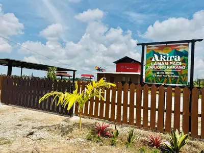 a fence in front of a restaurant with a sign at Akira Laman Padi Tg Karang in Tanjung Karang