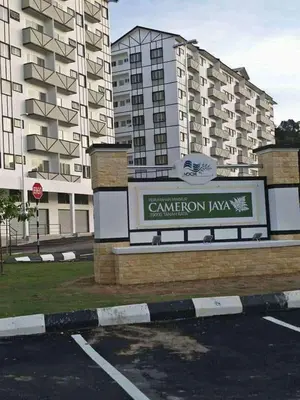 a sign in a parking lot in front of a building at Cikgu Husni Homestay Apartment Cameron Highlands in Tanah Rata