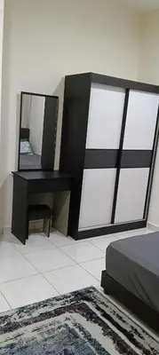 a bedroom with a mirror and a bed and a desk at Nausha Homestay Mus-lim ONLY in Kulim