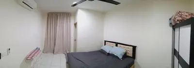 a bedroom with a bed with blue pillows on it at Nausha Homestay Mus-lim ONLY in Kulim