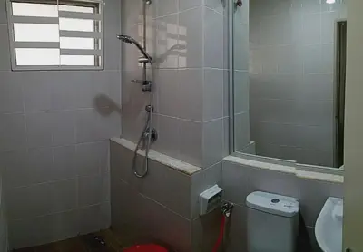 a bathroom with a shower and a toilet and a sink at Nausha Homestay Mus-lim ONLY in Kulim
