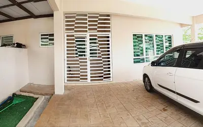 a white car parked in front of a house at Nausha Homestay Mus-lim ONLY in Kulim