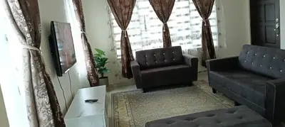a living room with two chairs and a couch at Nausha Homestay Mus-lim ONLY in Kulim