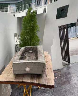 a wooden table with a box on top of it at Dream Home Landed Balik Pulau in Balik Pulau