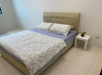 a bedroom with a bed and a night stand at Dream Home Landed Balik Pulau in Balik Pulau