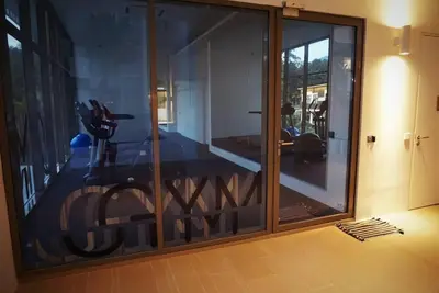 a glass door with a view of a room at Ferringhi Luxury Suite @ By The Sea in Batu Ferringhi