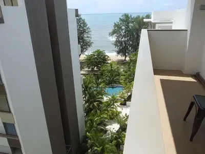 a view of the beach from the balcony of a building at Ferringhi Luxury Suite @ By The Sea in Batu Ferringhi