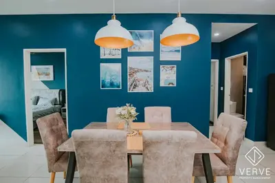a dining room with blue walls and a table and chairs at Ipoh D Festivo 2B2B Suite by Verve EECH189 in Ipoh