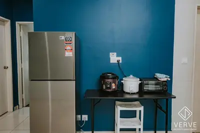 a kitchen with a table with a refrigerator and a table with a stove at Ipoh D Festivo 2B2B Suite by Verve EECH189 in Ipoh