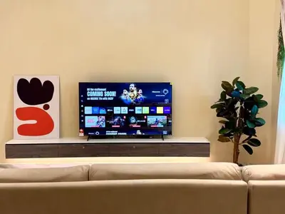 a television in a living room with a couch at Warm & Cozy Home in Kampong Duson Gilap