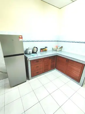 a kitchen with a refrigerator and a tiled floor at D'Manjung Samudera Baru HomeSTAY in Seri Manjung