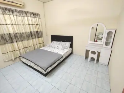 a small bedroom with a bed and a mirror at D'Manjung Samudera Baru HomeSTAY in Seri Manjung