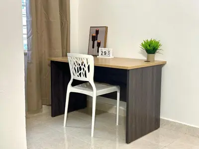 a desk with a white chair in a room at Vintage-Living 2Storey Haus12Pax in Simpang Ampat