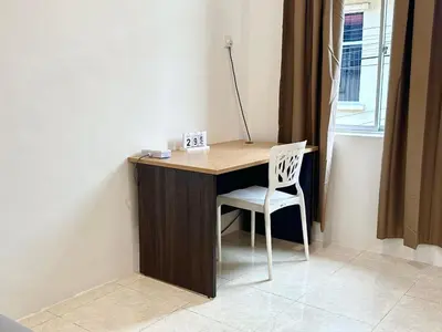a wooden desk with a chair and a lamp on it at Vintage-Living 2Storey Haus12Pax in Simpang Ampat