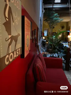 a red couch against a wall in a restaurant at Bitterswiit Ladies Hostel in George Town