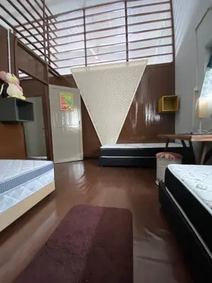 a room with two beds and a net at Bitterswiit Ladies Hostel in George Town