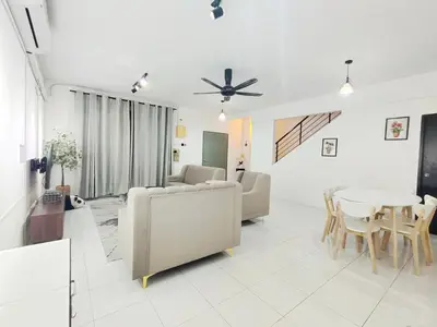 a living room with a couch and a table at Homestay Sungai Petani 4 Bedroom in PRIMA Bandar Puteri Jaya by D'Aleena Homes in Sungai Petani