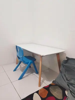 a blue chair sitting next to a white table at Homestay Sungai Petani 4 Bedroom in PRIMA Bandar Puteri Jaya by D'Aleena Homes in Sungai Petani