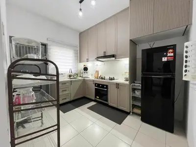 a kitchen with a black refrigerator and white cabinets at Homestay Sungai Petani 4 Bedroom in PRIMA Bandar Puteri Jaya by D'Aleena Homes in Sungai Petani