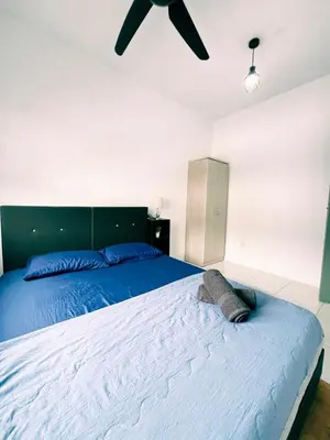 a bedroom with a large bed with a ceiling fan at Homestay Sungai Petani 4 Bedroom in PRIMA Bandar Puteri Jaya by D'Aleena Homes in Sungai Petani