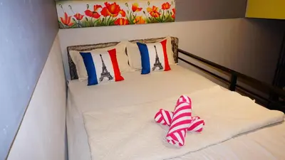 a bed with two pairs of slippers on it at Cozy Loft Bed Mini Studio Golf View in Gua Sai