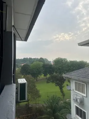 a view of a green field from a building at Cozy Loft Bed Mini Studio Golf View in Gua Sai