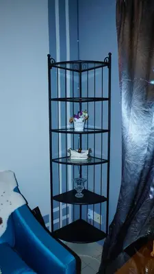 a black shelf with a bowl of flowers on it at Cozy Loft Bed Mini Studio Golf View in Gua Sai