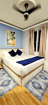 a bedroom with a large bed with blue walls at #MyHighlandGetaway at OmniCassia Cameron Highlands in Cameron Highlands