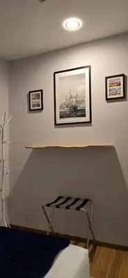 a room with a shelf and pictures on the wall at #MyHighlandGetaway at OmniCassia Cameron Highlands in Cameron Highlands