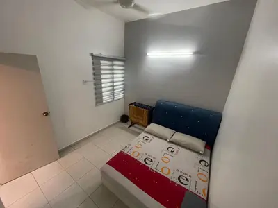 a small bedroom with a blue bed and a window at MieMar Homestay Gopeng in Gopeng