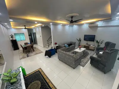 a living room with couches and a dining room at MieMar Homestay Gopeng in Gopeng