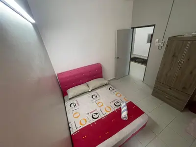 a small bedroom with a red bed in a room at MieMar Homestay Gopeng in Gopeng