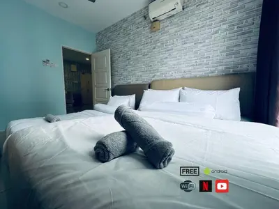 a bed with a teddy bear laying on it at 12pax 3-Bedroom l Seaview l Georgetown l Gleneagles l Mansion One in George Town