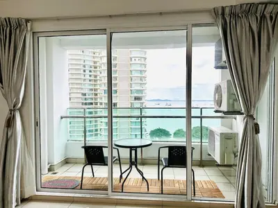 a room with a balcony with a table and chairs at 12pax 3-Bedroom l Seaview l Georgetown l Gleneagles l Mansion One in George Town