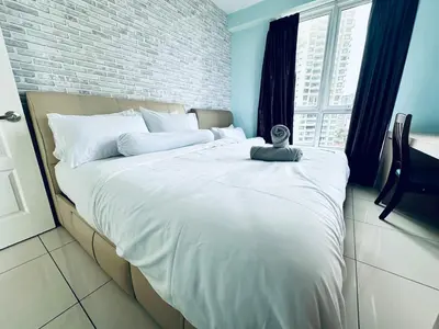 a large white bed in a room with a window at 12pax 3-Bedroom l Seaview l Georgetown l Gleneagles l Mansion One in George Town