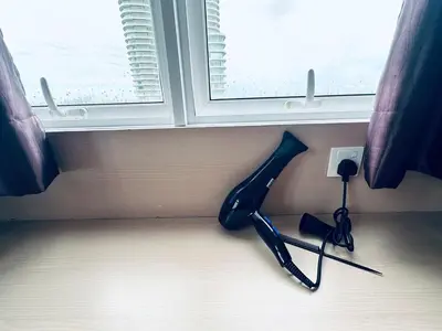 a pair of scissors sitting on the floor next to a window at 12pax 3-Bedroom l Seaview l Georgetown l Gleneagles l Mansion One in George Town