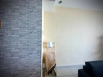 a room with a brick wall and a couch at 12pax 3-Bedroom l Seaview l Georgetown l Gleneagles l Mansion One in George Town