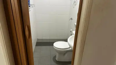 a bathroom with a white toilet and a shower at Serene Villa in Kepala Batas