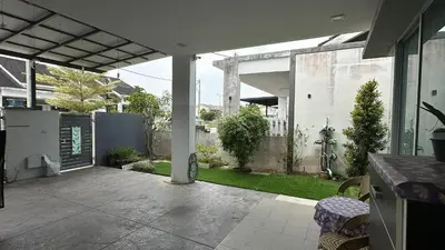 an open patio with a yard with a fence at Serene Villa in Kepala Batas