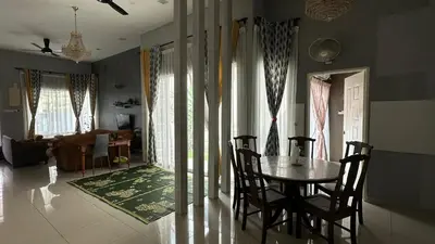 a dining room with a table and chairs at Serene Villa in Kepala Batas