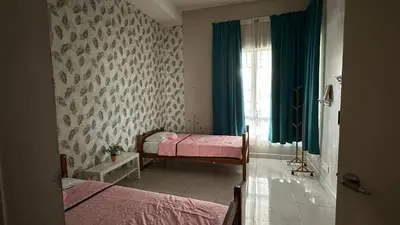 a bedroom with two beds and a window at Serene Villa in Kepala Batas