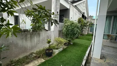 a garden with plants on the side of a building at Serene Villa in Kepala Batas