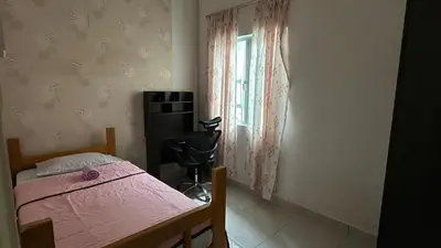 a bedroom with a pink bed and a window at Serene Villa in Kepala Batas