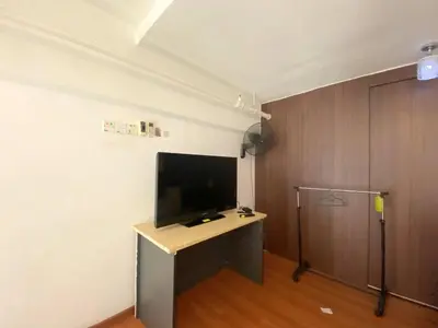a living room with a tv and a desk with a television at Minimalist Balcony Duplex w Netflix at Bayan Lepas in Bayan Lepas